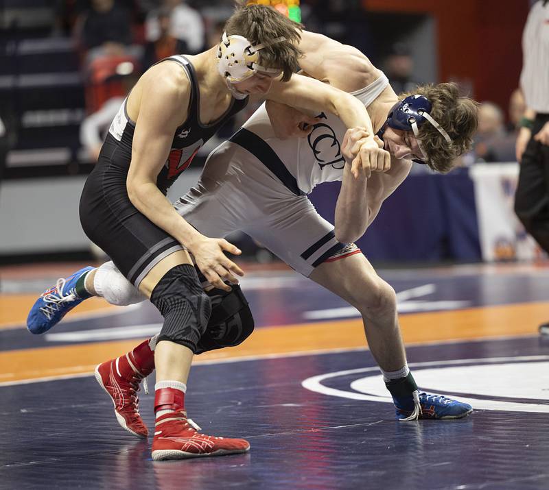 IC Catholic’s Max Cumbee (right) works against Morton’s Harrison Dea in the 2A 132 pound class Saturday, Feb. 21, 2026, at the IHSA wrestling finals in Champaign.
