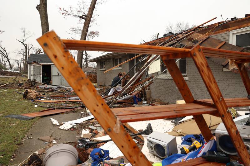 Emily LaVoie walks through the damage to her home along Elmwood Drive in Aroma Township on Wednesday, March 11, 2026, following the March 10 tornado in Kankakee County.