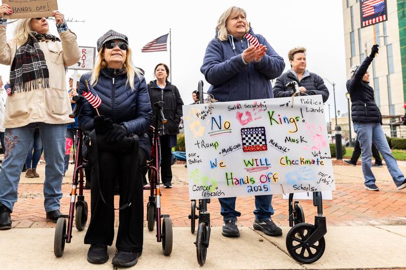 Burbank resident Ann Daviduke and Sue Knowski, of Joliet, participate in the Hands Off protest in Downtown Joliet on April 5, 2025.