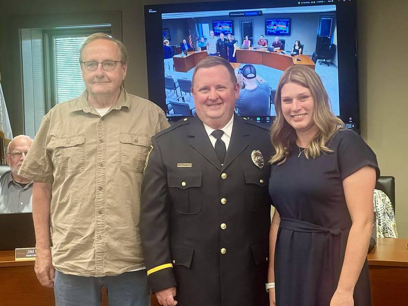 Sterling Police Department's newly appointed Deputy Chief of Support Services, Ryan Potthoff, stands with his father, Ron Potthoff, and his wife, Michelle Potthoff, during a City Council meeting on July 7, 2025.
