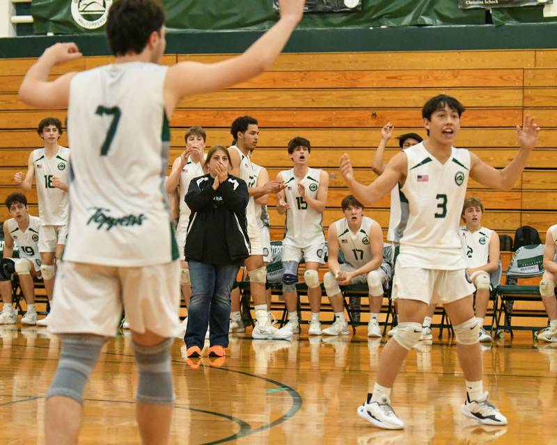 Glenbard West's head coach Christine Giunta along with Glenbard West teammates Adam Graham (7) and Glenbard West's Zachary Weinberg (3) celebrates after the team gets a point during the game on Tuesday April 16, 2024, while taking on Oak Park-River Forest.