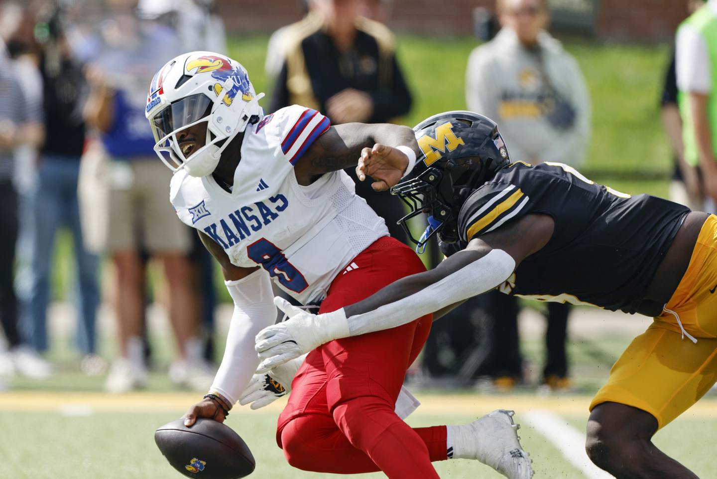 Kansas quarterback Jalon Daniels, is unable to get away from Missouri defensive end Zion Young, right, fumbling the ball during the first half of an NCAA college football game on Saturday, Sept. 6, 2025, in Columbia, Mo. (AP Photo/Colin E. Braley)