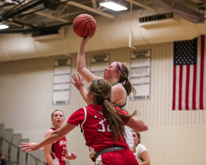 York's Hannah Meyers (20) puts up a shot during basketball game between Hinsdale Central at York. Dec 8, 2023.