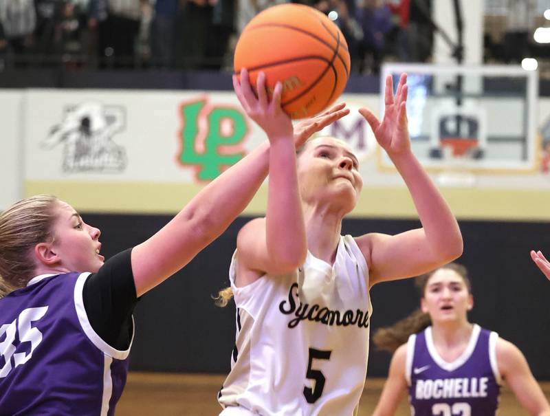Sycamore's Grace Amptmann gets to the basket in front of Rochelle's Emma Kennay during their game Wednesday, Dec. 6, 2023, at Sycamore High School.