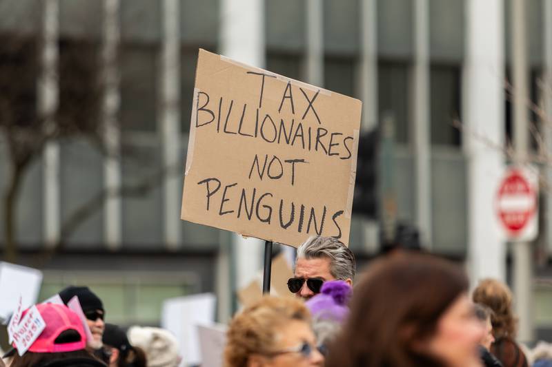 An attendee holds up a sign at the Hands Off protest in Downtown Joliet on April 5, 2025.