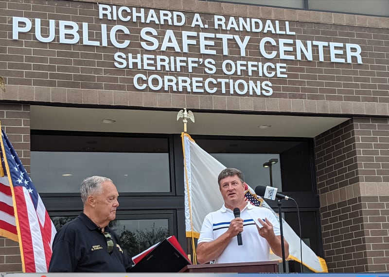 Kendall County Board Chairman Matt Kellogg, right, on Aug. 6 helped dedicate the Kendall County Public Safety Center to former Kendall County sheriff Richard Randall, left, on Aug. 6, 2024.