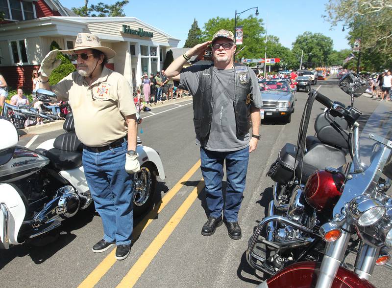 Barry Desfor, Army veteran, and Tommy Carr, Air Force veteran, both of Wauconda stop and salute Monday, May 29, 2023, on Main Street during the Wauconda Memorial Day Parade.