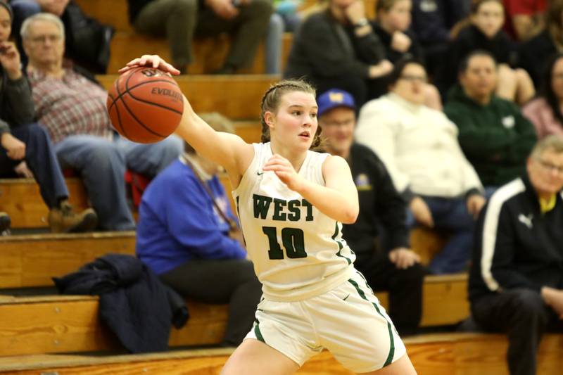 Glenbard West’s Julia Benjamin grabs a pass during a game against Lyons Township in Glen Ellyn on Tuesday, Dec. 12, 2023.