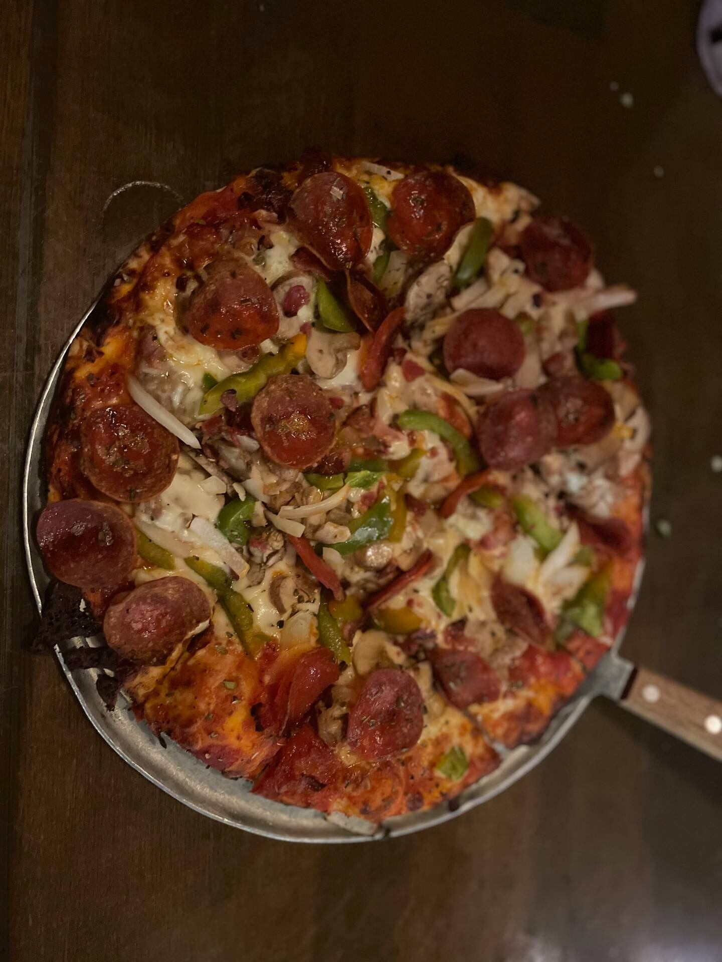 The Papa Georgio pizza (thin crust $18.85, $26.85,  deep dish $24.85, $32.65) loaded with sausage, mushroom, onion, green pepperoni and bacon on a thin crust at Georgio's Chicago Pizzeria & Pub, 75 E Woodstock St. in Crystal Lake.