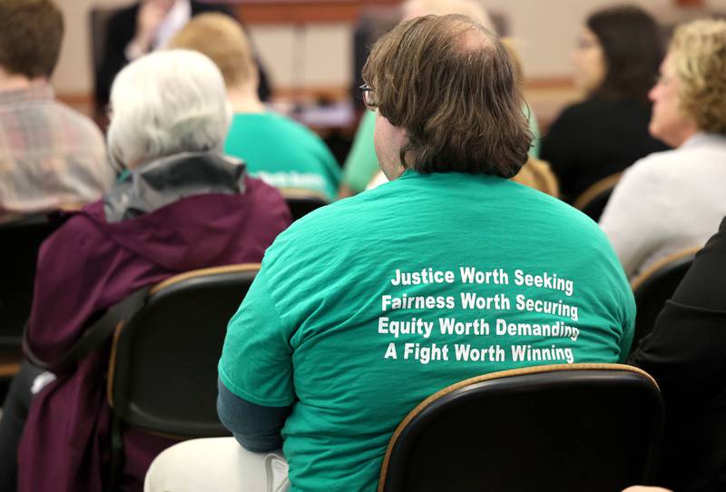 Many people attending the Northern Illinois University Board of Trustees meeting wore AFSCME shirts with this slogan Thursday, Sept. 21, 2023, in Altgeld Hall on campus in Dekalb. Several NIU employees, represented by the American Federation of State, County and Municipal Employees, attended the meeting seeking a fast resolution to a contract with higher pay.