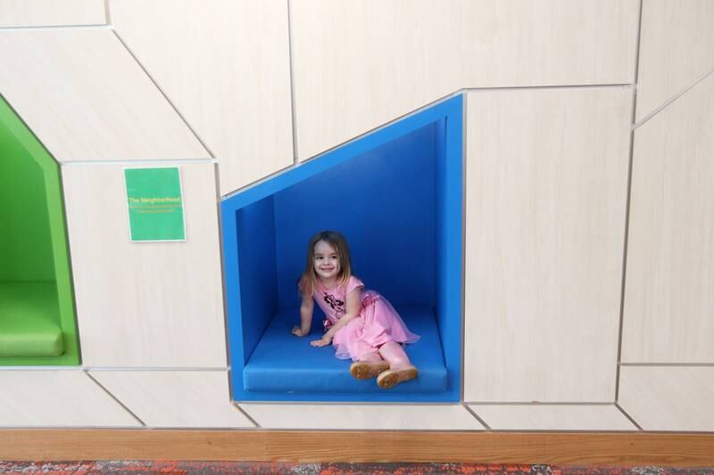 Mia Groth, 3, of Libertyville has fun sitting on a seat in the The Neighborhood Saturday, May 13, 2023, during the Antioch Public Library District Open House in Antioch.