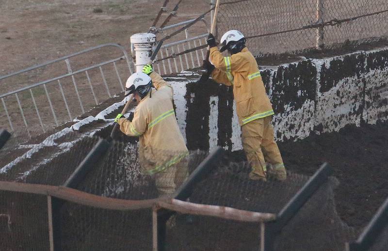 Crews remove mud off of the interior wall during the season opening race on Tuesday, May 6, 2025 at La Salle Speedway.