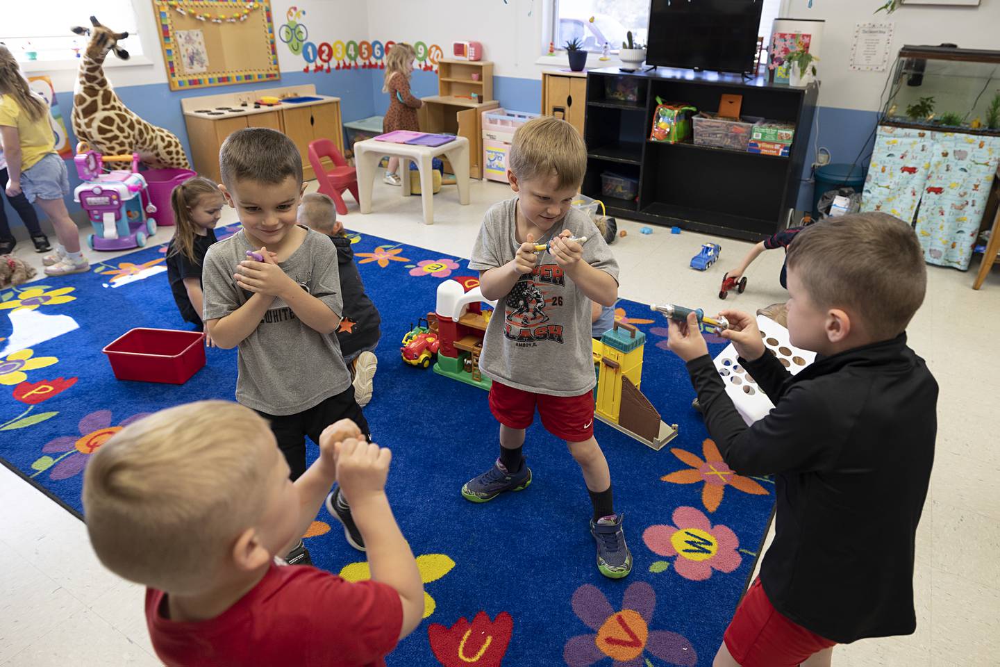 Young boys play with one another Monday, May 11, 2026, at Clipper Kiddies daycare in Amboy. The school will be closing at the end of the school year.