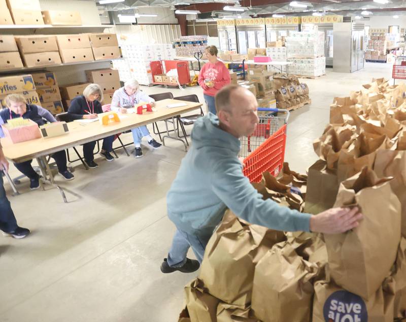Volunteer Dan Forbs collects grocery bags that were handed out during the Easter distribution on Wednesday, March 25, 2026 at the Illinois Valley Food Pantry in Peru.