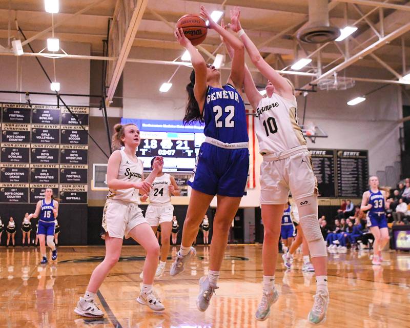 Geneva Leah Palmer (22) makes a basket while being defended by Sycamore Lexi Carlsen (10) during the second quarter Thursday Feb 9th held at Sycamore High School.