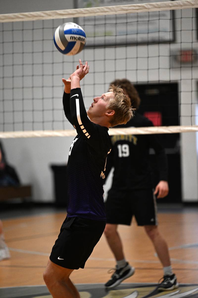 Manteno's Mason McElroy sets the ball at the match against Kankakee Trinity Academy on Thursday, May 1, 2025.
