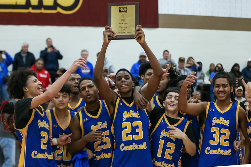 Joliet Central celebrates with the WJOL Tournament Championship game plaque. Nov 25, 2023.