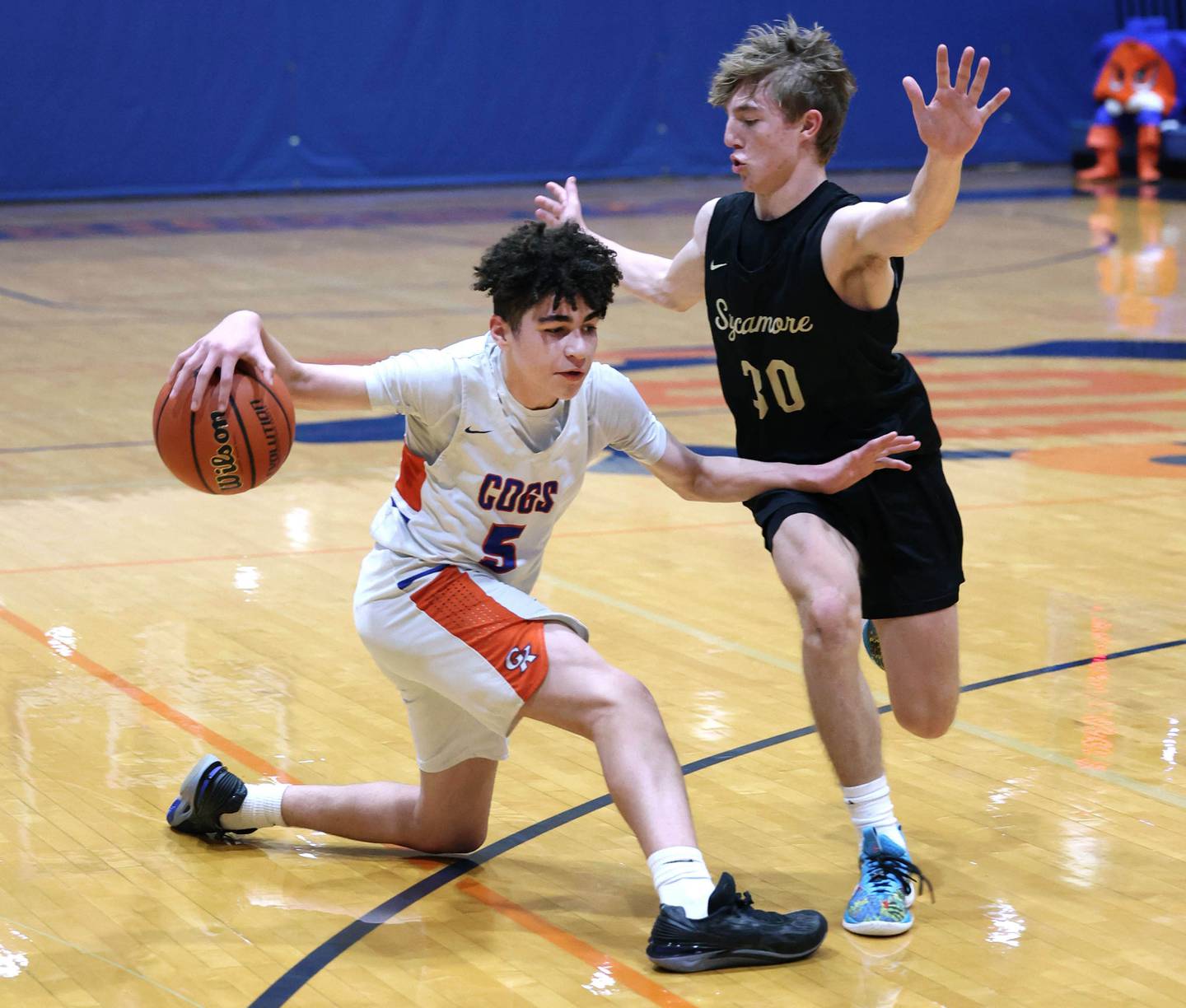 Genoa-Kingston's Marcus Johnson works against Sycamore's Xander Lewis during their game Wednesday, Feb. 14, 2024, at Genoa-Kingston High School.