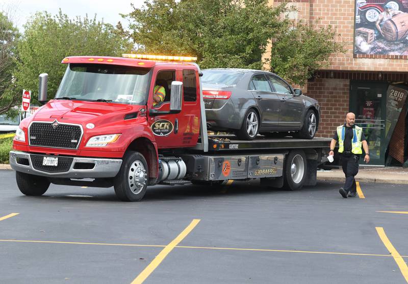The car that crashed into a Portillo’s Wednesday, July 30, 2025, is removed from the front entrance of the business at 2810 U.S. Route 34 in Oswego injuring 12.
