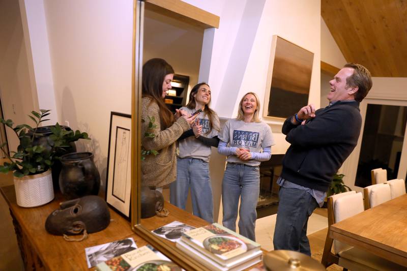Geneva Mayor Kevin Burns, running for re-election, shares a laugh with (from left) daughers Emma Burns, Flo Burns and partner Aimee Bychowski as they await election results at his home on Tuesday, April 1, 2025 in Geneva.