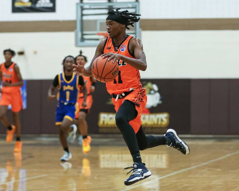 Romeoville's TJ Lee (11) drives to the basket in the WJOL Tournament Championship game. Nov 25, 2023.