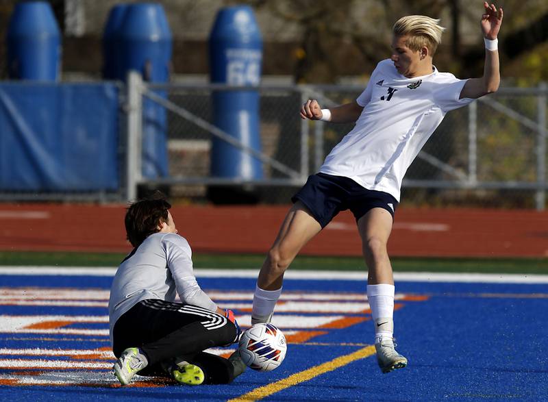 Lemont’s Andrew Guzy priest to kick the ball into the goals as Belleville Althoff Catholic's Zach Winkler plays the ball during an IHSA Class 3A state semifinal soccer match on Friday, Nov. 8, 2024, at Hoffman Estates High School.