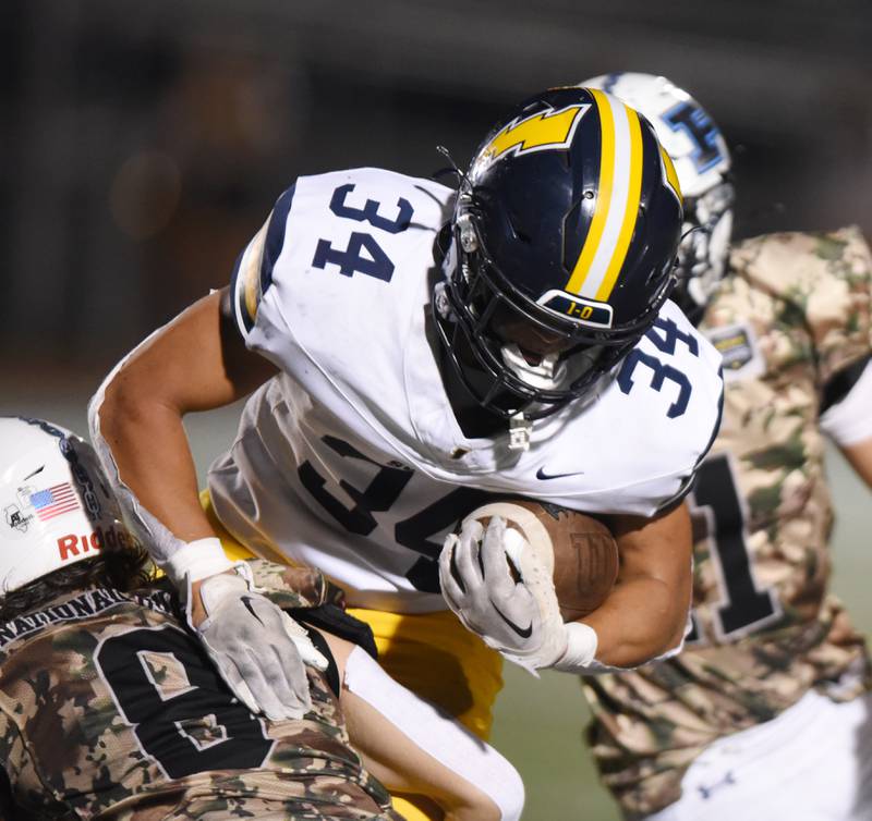 Joe Lewnard/jlewnard@dailyherald.com
Glenbrook South's Nate Canning gets tackled by Prospect’s Charlie Knee during Thursday’s game in Mount Prospect.
