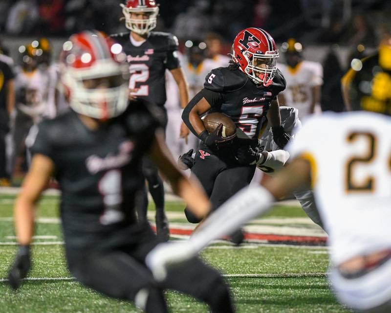 Yorkville's TJ Harland (5) runs the ball during the game while taking on Joliet West on Friday Sept. 5, 2025, held at Yorkville High School.