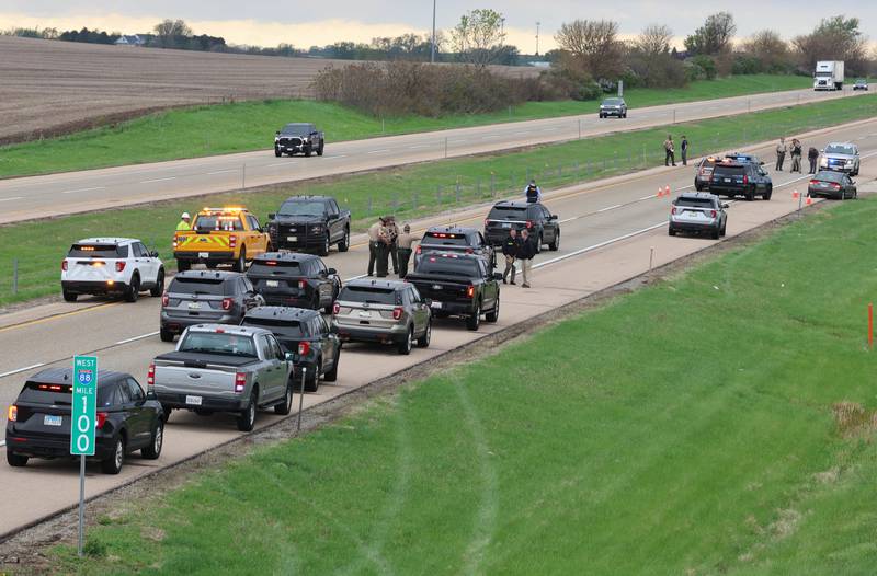 Several law enforcement vehicles sit near a Honda sedan with a shattered window in the westbound lanes of Interstate 88 Monday, April 27, 2026, as they investigate an incident on I-88 just west of Keslinger Road in Maple Park.