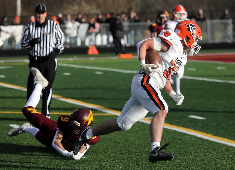 Richmond-Burton's Cooper Nagel  can’t tackle Byron’s Caden Considine as he runs with the football during an IHSA Class 3A semifinal playoff football game on Saturday, November 22, 2025, at Richmond-Burton High School, in Richmond.