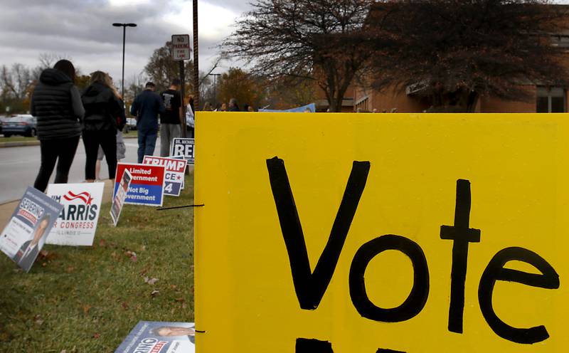 People wait in line to vote on Monday, Nov. 4, 2024, at the McHenry City Hall in McHenry.