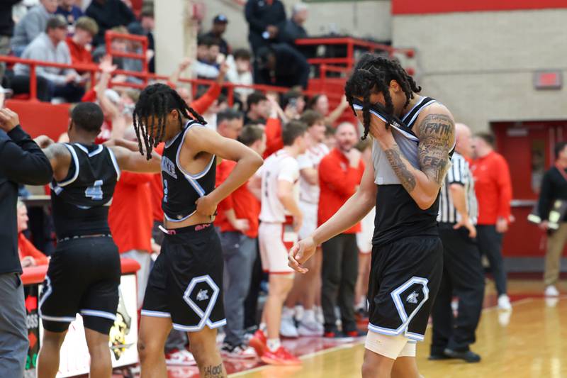 Kankakee's Lincoln Williams, right, Kenaz Jackson, center, and Myair Thompson leave the court as Morton celebrates in the background following the Kays' 61-48 loss to Morton in the IHSA Class 3A Ottawa Sectional championship on Friday, March 6, 2026.