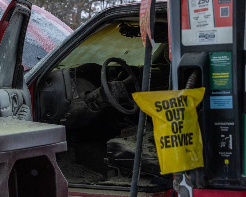 Charred remains of vehicle interior sit behind 'sorry out of service' sign at scene of internal electrical fire of vehicle near gas pump on Tuesday, December 30, 2025 at Casey's on 1100 Shooting Park Road in Peru. The fire was extinguished by 15 year old driver Jesus Gonzalez of Streator.