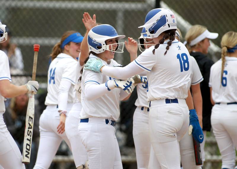 St. Charles North's Julianna Kouba (center) celebrates her home run during a game against Lake Park on Wednesday, April 30, 2025 in St. Charles.