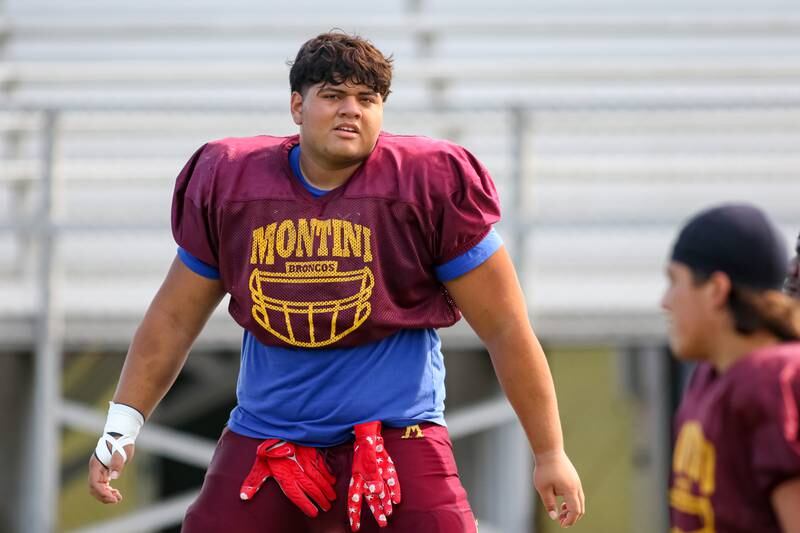 The team doing stretching before the start of Montini High School football practice. Aug 22 2024.