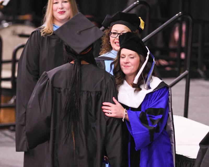 DeKalb High School principal Donna Larson shakes hands and congratulates seniors as they accept their diplomas during the Class of 2023 Commencement at Northern Illinois University's Convocation Center, 1525 W. Lincoln Highway in DeKalb Saturday, May 27, 2023.