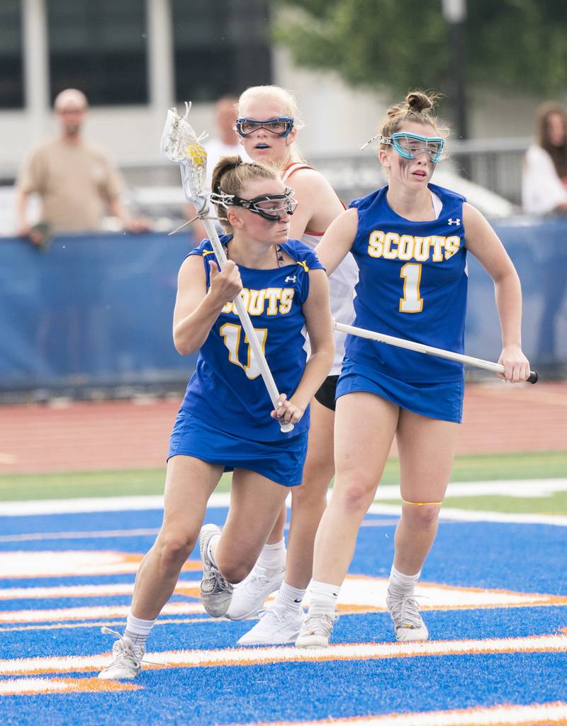 Lake Forest's Carli Kisselle gets control of the ball past Crystal Lake Central Co-Op's Lauren Hughes during the girls lacrosse supersectional match on Tuesday, May 31, 2022 at Hoffman Estates High School.