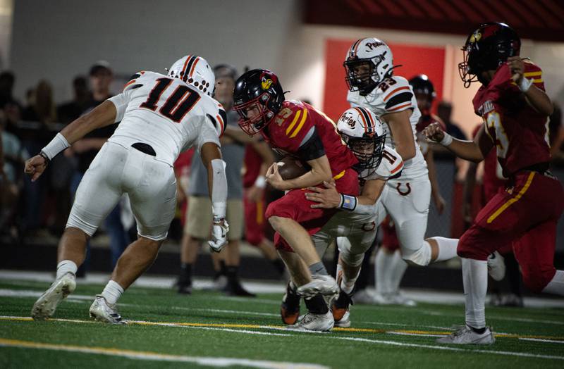 St. Anne's Raleigh Hays, center, is brought down by South Fork's Jhude Walker, right, and Stephon Shanks, left, as he carries the ball in a game on Friday, September 26, 2025.