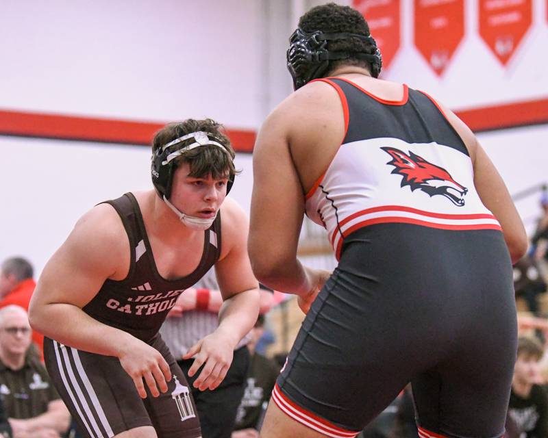 Derrick Pomatto of Joliet Catholic Academy keeps an on Yorkville’s Xavion Ulloa during the 285-weight class in the regional team match up on Tuesday Feb. 25, 2025, held at Yorkville High School.