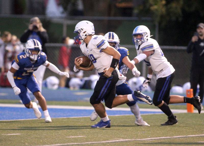 St. Charles North quarterback Ethan Plumb keeps the ball for a touchdown during a game at Wheaton North on Friday, Sept. 8, 2023.