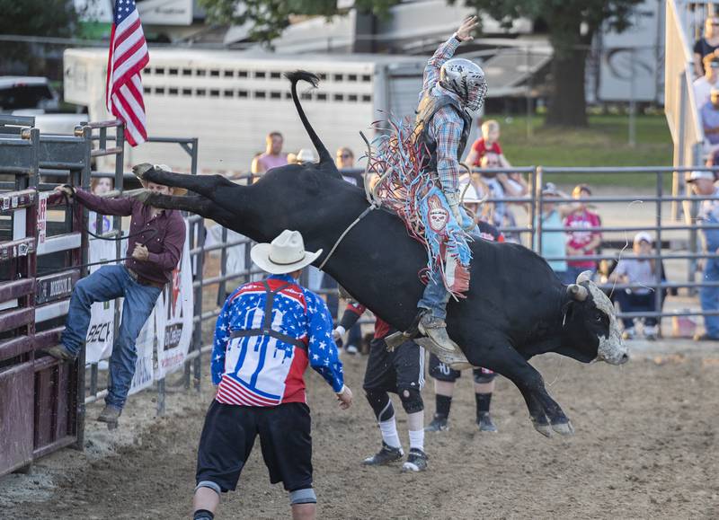 Daniel Carter gets big air on his bull Tuesday, August 15, 2023 in the Next Level Pro Bull Riding event at the Whiteside County Fair. The rodeo was the first grandstand event at the fair which runs until Saturday.