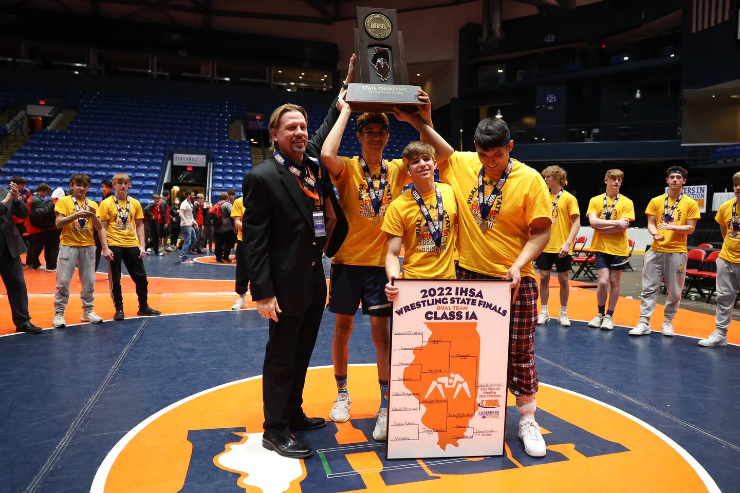 Yorkville Christian’s coach and team captains pose with the championship trophy after defeating Tremont in the Class 1A dual team championship at Grossinger Motor Arena in Bloomington. Saturday, Feb. 26, 2022, in Champaign.