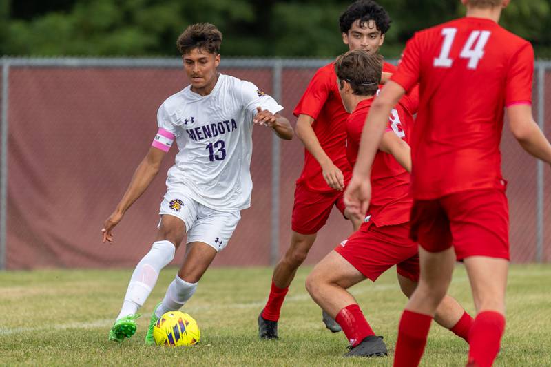 Sebastian Carlos (13) of Mendota pushes ball upfield whilst being surrounded by Streator's defense on Saturday, Aug 30, 2025 at the James Street Recreation Area in Streator.