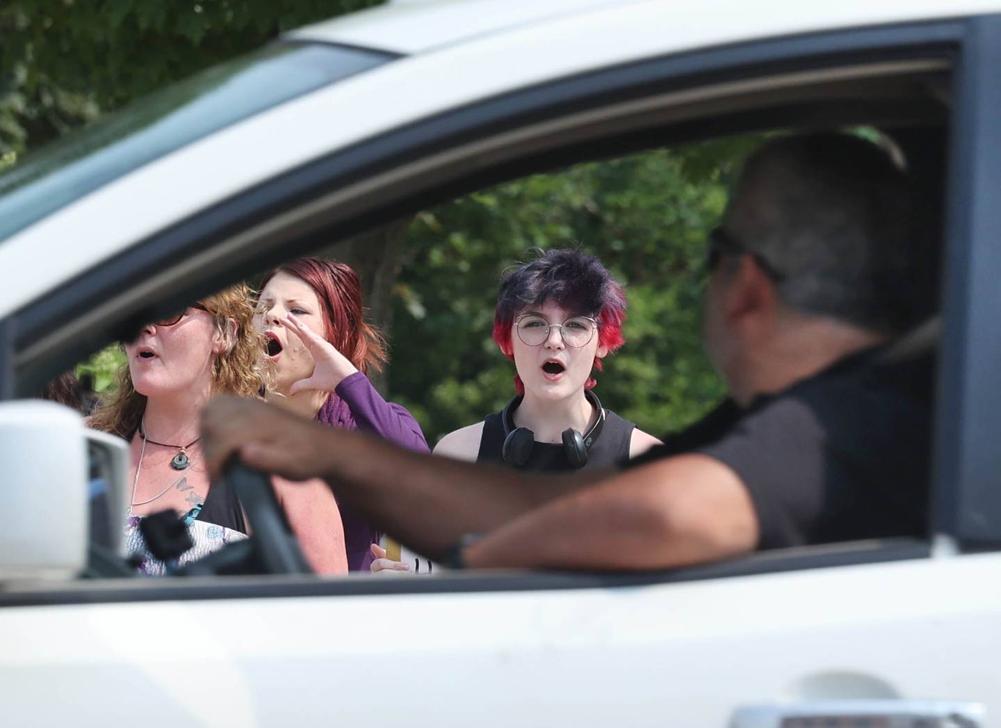 Protesters chant at passing motorists Wednesday, June 14, 2023, in front of the DeKalb County Courthouse in Sycamore. The group is asking for harsher sentences for those convicted of domestic or sexual abuse. They gathered shortly after the arraignment hearing of Timothy M. Doll, a registered sex offender charged with murder in DeKalb teenager Gracie Sasso-Cleveland’s death.
