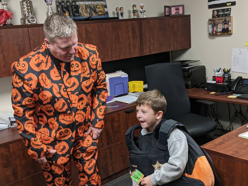 As part of an open house of the Sandwich Police Department's new Public Safety Center on Oct. 25, Sandwich resident Lincoln Libner, 5, got to meet Sandwich Police Chief Kevin Senne, who gave him a police vest to try on.