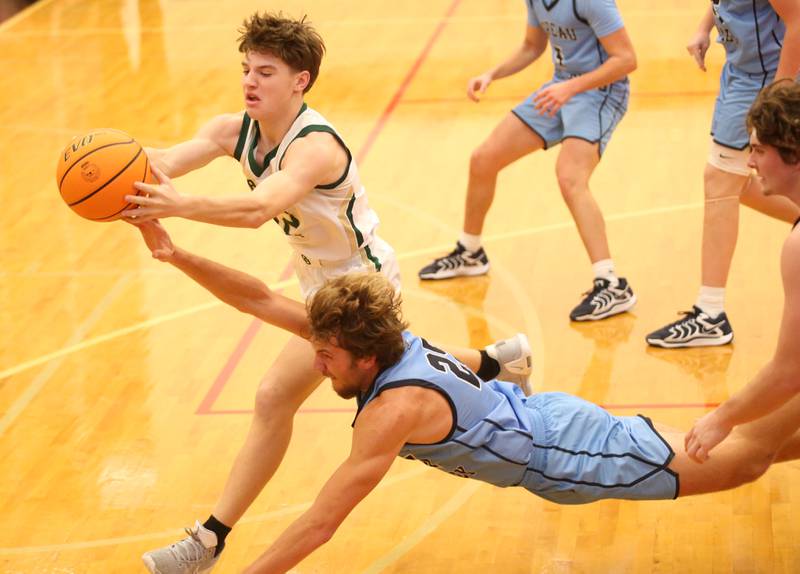 St. Bede's Carson Riva grabs a rebound as Bureau Valley's Landon Hulsing dives for the ball during the 50th annual Colmone Classic on Thursday, Dec. 12, 2024 at Hall High School.