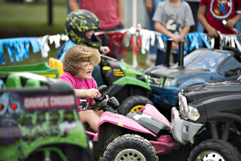 Willow Shepard, 5, of Fulton supplies a hard hit on an opponent during the kid's demo derby at Peat Monster in Morrison on Saturday, Sept. 4, 2021. Half a dozen kids brought in their Powerwheels to go at it like the big kids. The venue played host to the World Series of Demo Derby with over 60 cars smashing it up during the day.