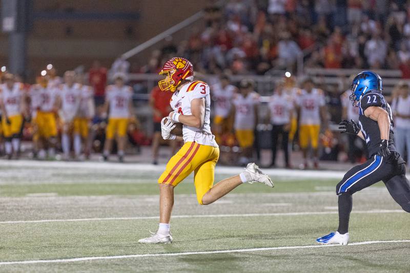 Batavia's Thomas Prescott makes the running catch past St. Charles North's Josh Wilkerson on Friday, Sept. 26, 2025 in St. Charles.