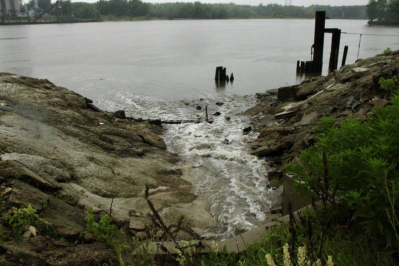 Water pours from a storm drain into the Illinois River on Saturday near to the boat ramp in Hennepin.