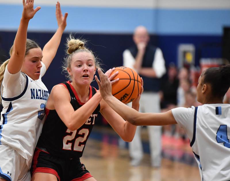 Benet’s Bridget Rifenburg (22) looks to pass as she’s double teamed by Nazareth’s Lyla Shelton and Mia Gage (4) during a game on December 13, 2025 at Nazareth Academy in LaGrange Park.